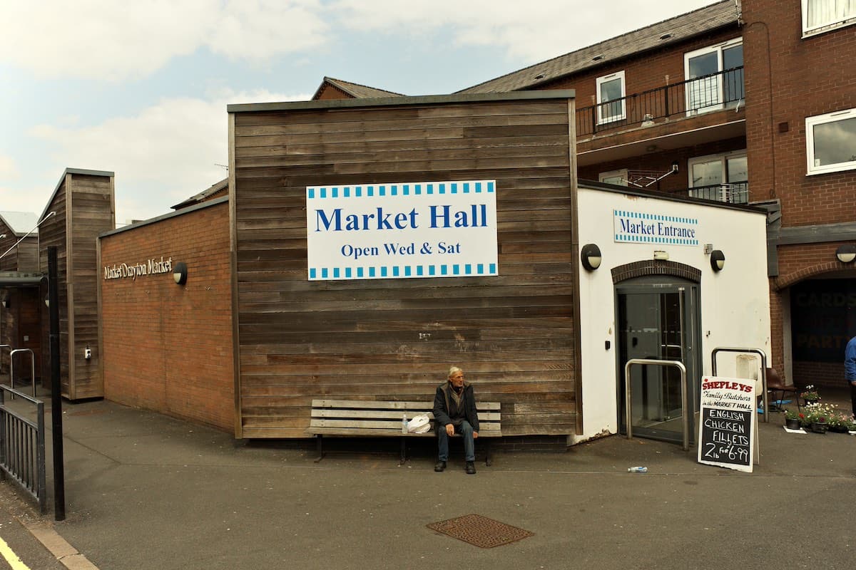 the front entrance with blue and white signs of market drayton indoor market hall