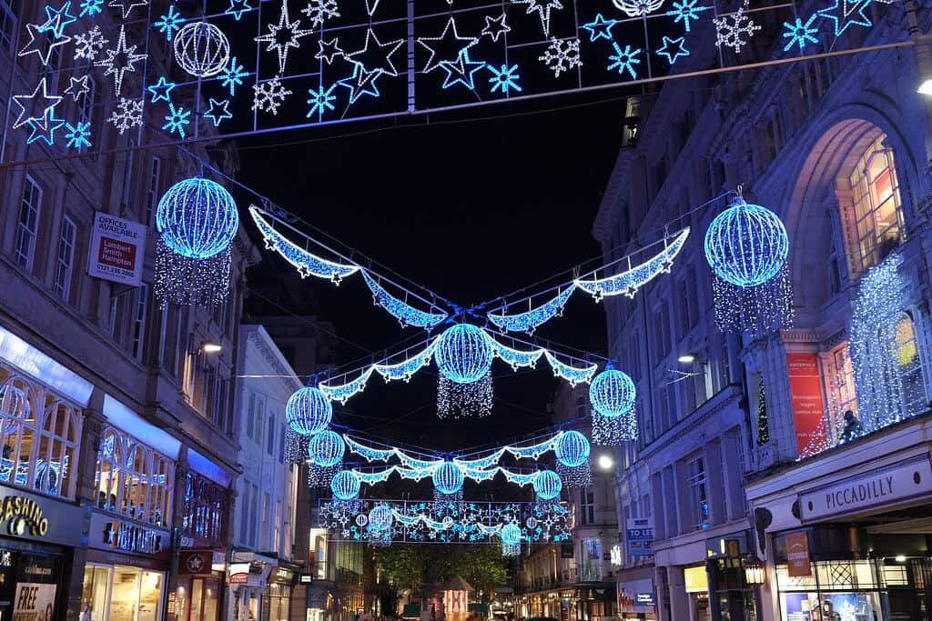 Birmingham Christmas Lights displaying various hues of blue, purples and whites in an icy themed style against a dark sky, hanging above New Street in Birmingham