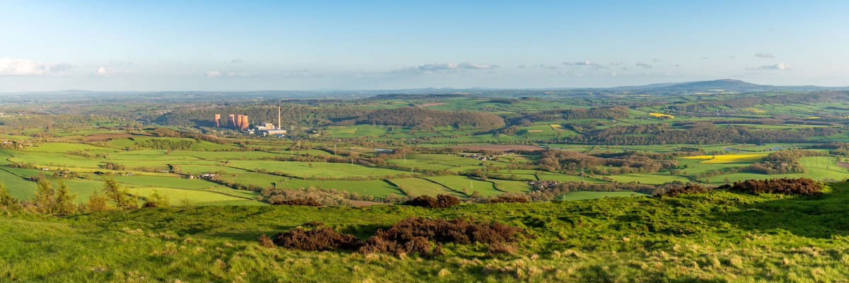 views from the peak of the wrekin, showing vast countryside and the old derelict ironbridge power station visible in the distance