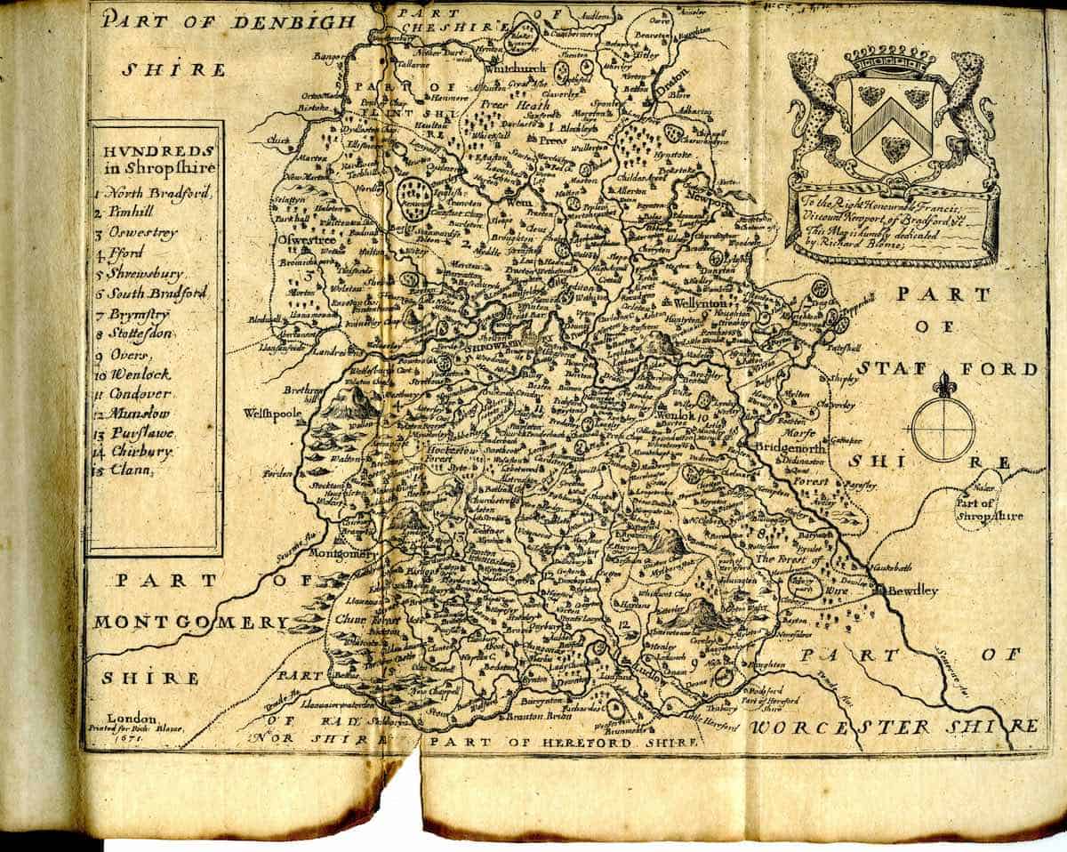 Historical 1671 map of Shropshire, England, listing hundreds (administrative divisions) such as North Bradford, Hanhill, and Clun, with bordering regions like Denbighshire and Herefordshire.