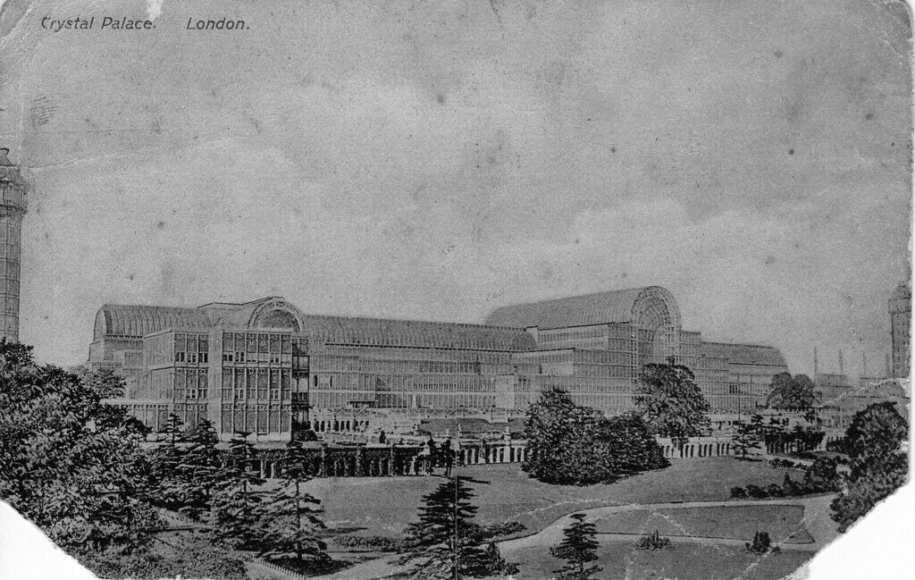 black and white photo of The Crystal Palace, a groundbreaking Victorian-era exhibition hall made of glass and iron, shown here in its original Hyde Park location before its relocation to south London.