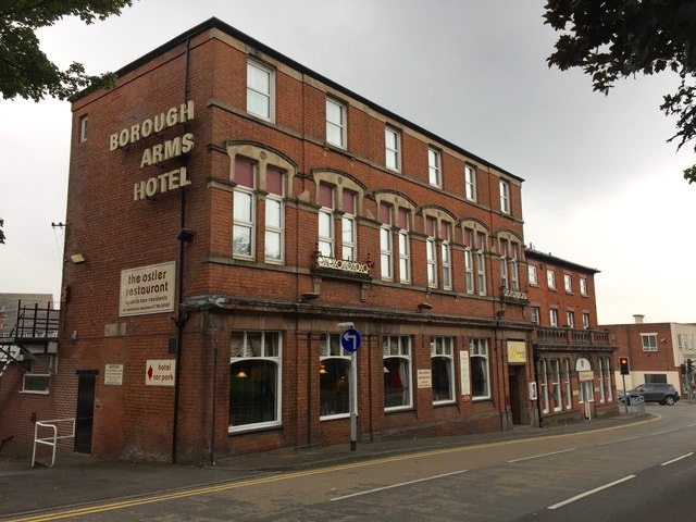 the borough arms hotel, a red brick, edwardian style town building with large hotel sign on the side of the building, on a road in Newcastl-under-Lyme, Staffordshire.