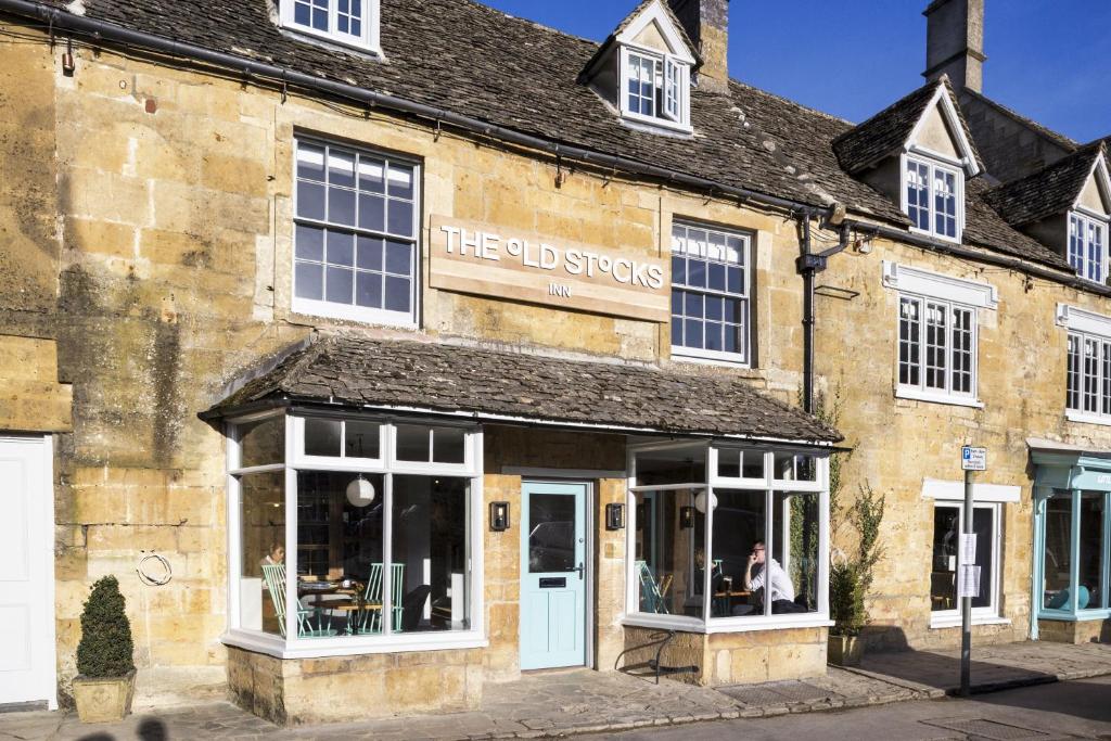 The charming facade of The Old Stocks Inn in Stow-on-the-Wold, a refurbished 17th-century coaching inn located right on the historic market square.